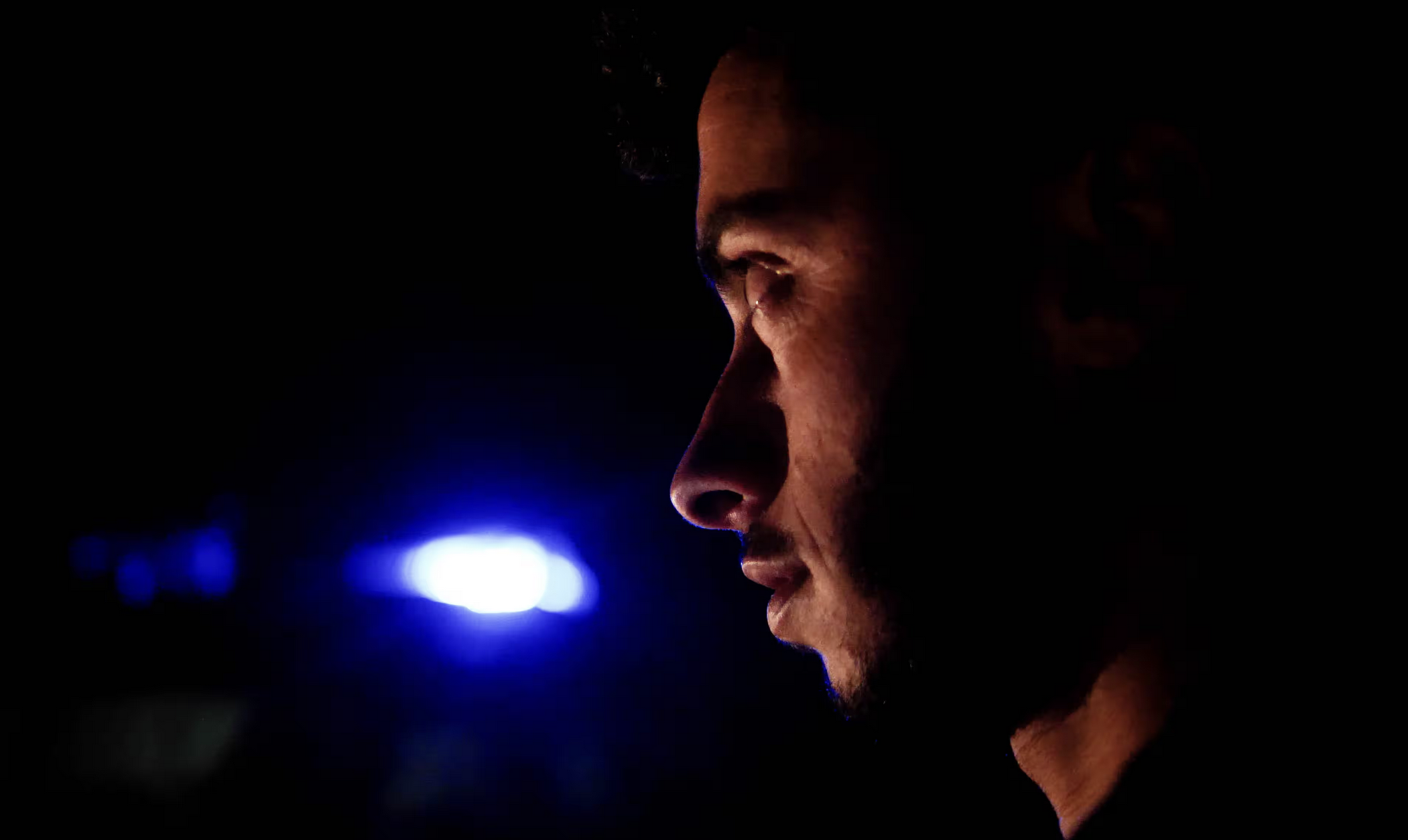 A photograph of a person looking to the left.